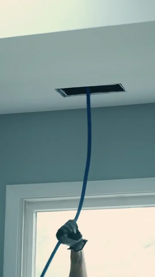 Technician cleaning an air vent in a San Antonio home